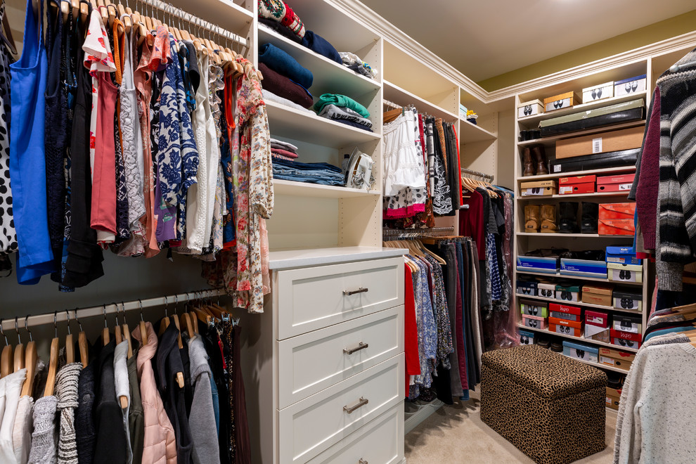 Example of a mid-sized mountain style gender-neutral carpeted and beige floor walk-in closet design in Other with shaker cabinets and white cabinets