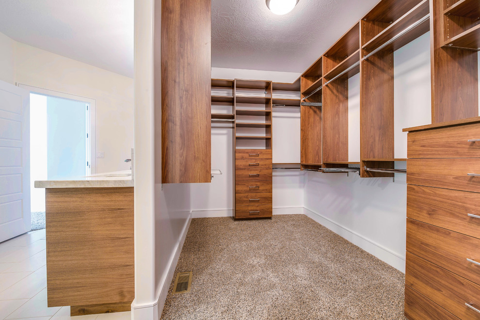 Inspiration for a mid-sized contemporary carpeted and brown floor walk-in closet remodel in Salt Lake City with flat-panel cabinets and medium tone wood cabinets