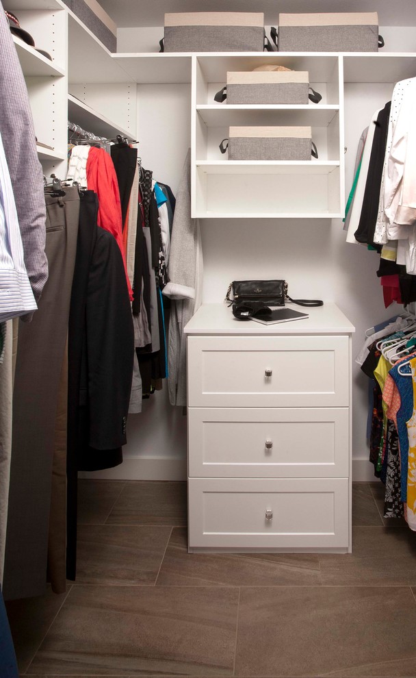 This is an example of a medium sized classic gender neutral walk-in wardrobe in Seattle with shaker cabinets, white cabinets and porcelain flooring.