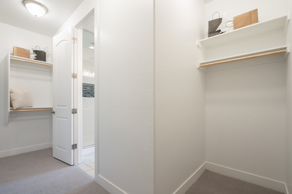 Example of a mid-sized trendy carpeted and beige floor walk-in closet design in Phoenix