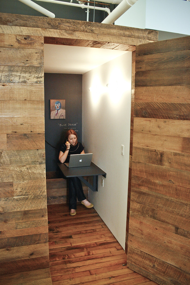 Inspiration for a mid-sized modern gender-neutral medium tone wood floor closet remodel in New York