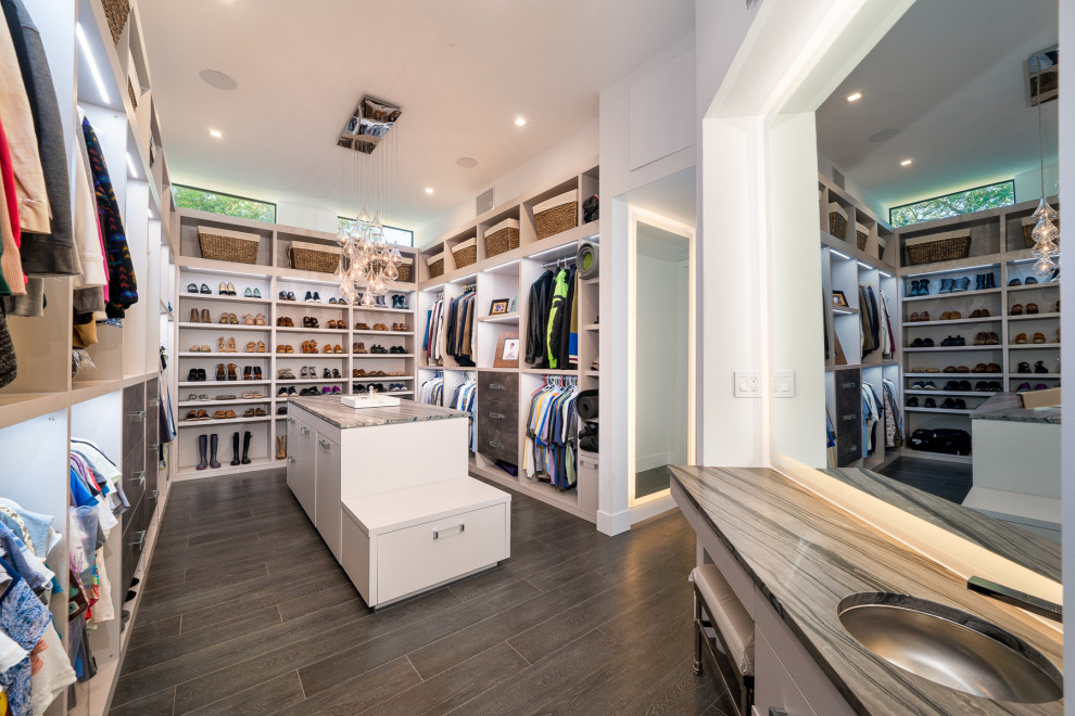 Inspiration for a contemporary walk-in wardrobe in Miami with open cabinets, white cabinets and grey floors.