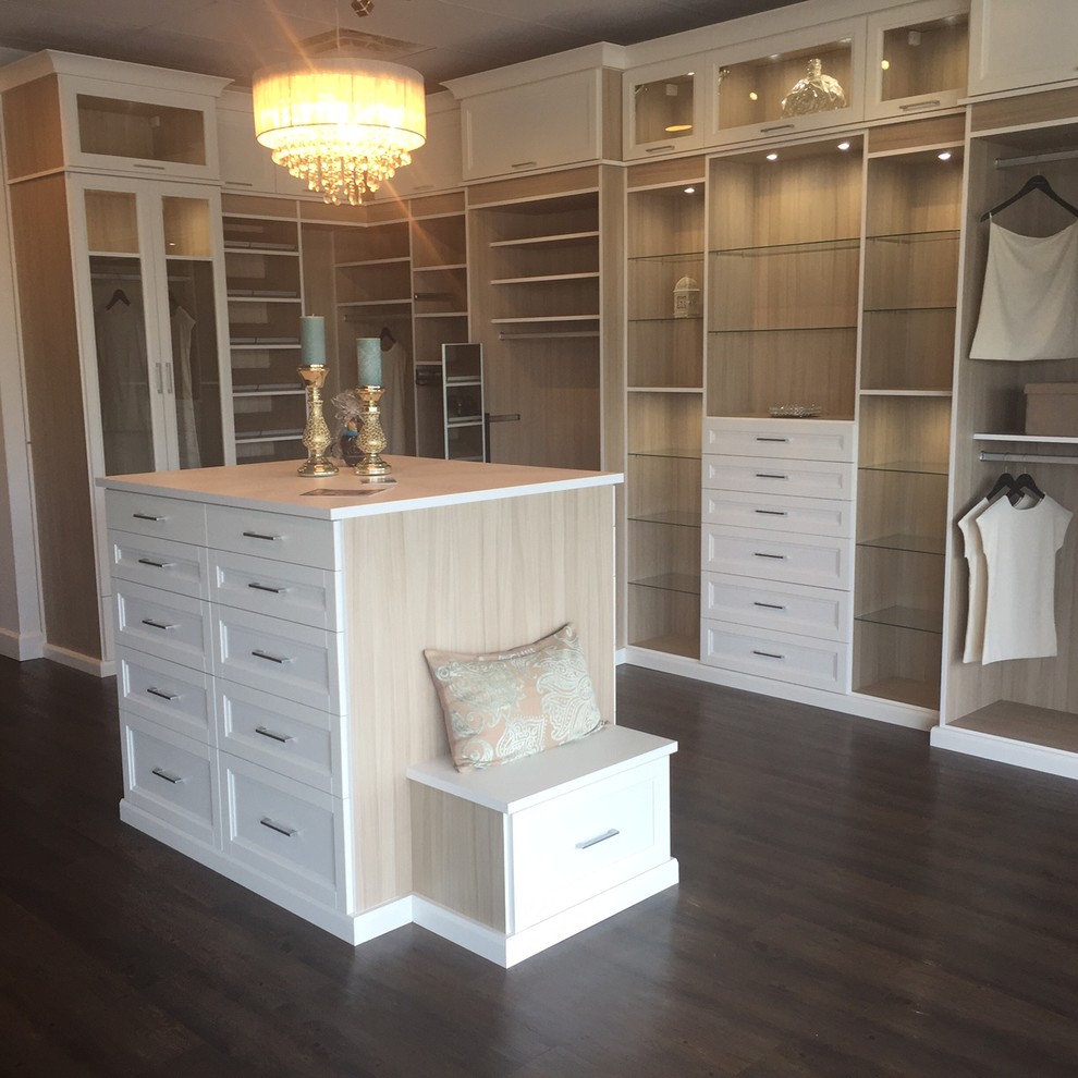 Design ideas for a large traditional gender neutral walk-in wardrobe in Jacksonville with recessed-panel cabinets, white cabinets and dark hardwood flooring.