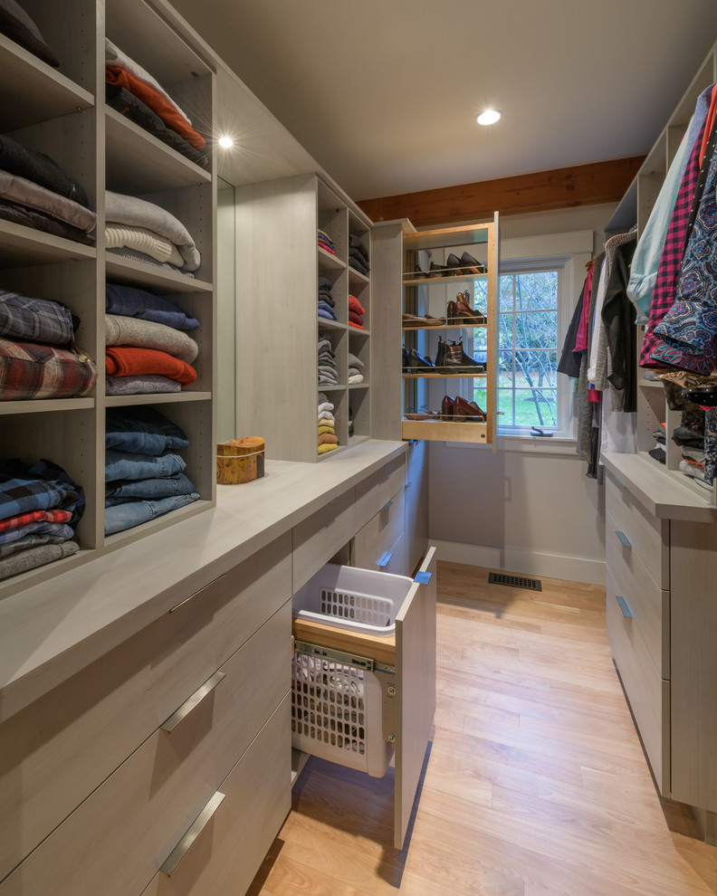 Inspiration for a large contemporary gender-neutral light wood floor walk-in closet remodel in Other with flat-panel cabinets and gray cabinets