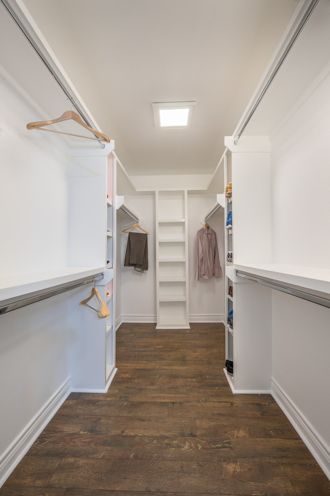 Inspiration for a large modern gender neutral walk-in wardrobe in Houston with open cabinets, white cabinets, medium hardwood flooring and brown floors.