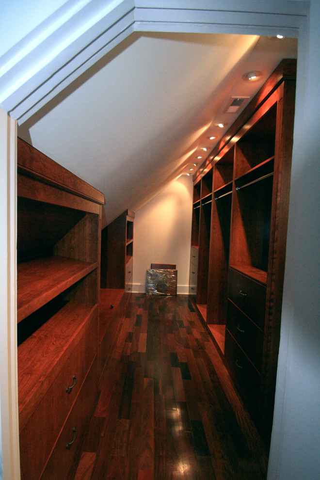 Diseño de armario vestidor unisex clásico grande con puertas de armario de madera oscura y suelo de madera oscura