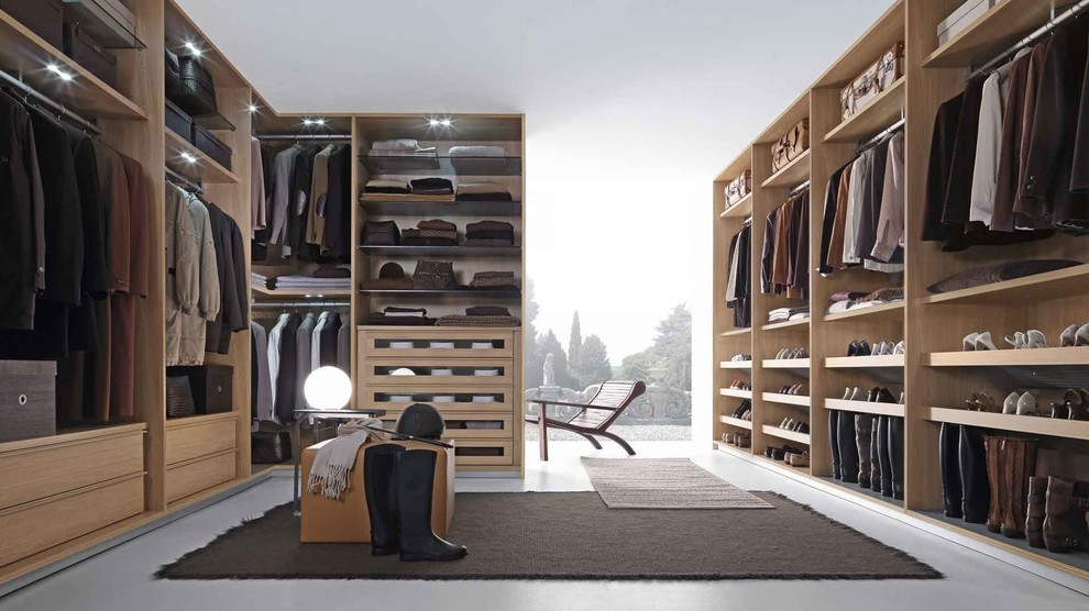 Design ideas for a large modern wardrobe in Boston with white floors and concrete flooring.