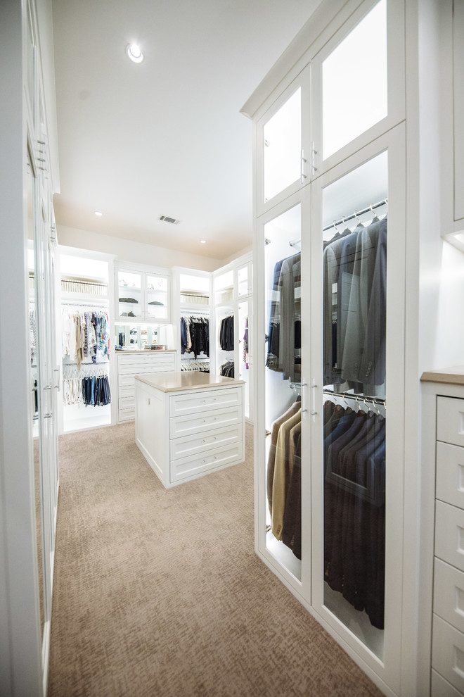 Large traditional gender neutral walk-in wardrobe in Dallas with white cabinets, carpet, beige floors and recessed-panel cabinets.