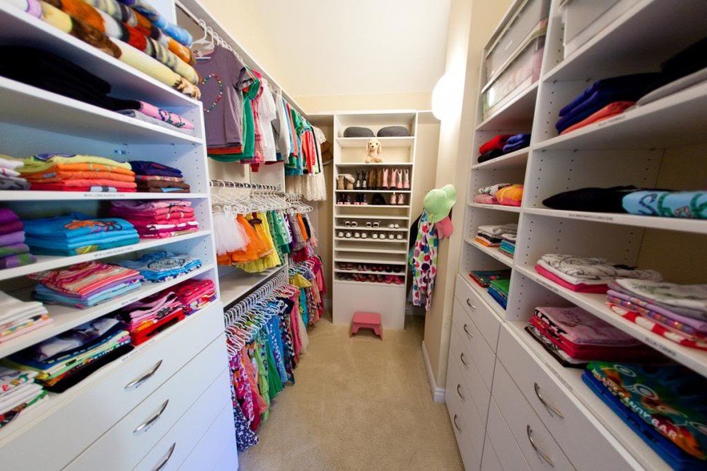 Example of a mid-sized minimalist women's carpeted walk-in closet design in Denver with open cabinets and white cabinets