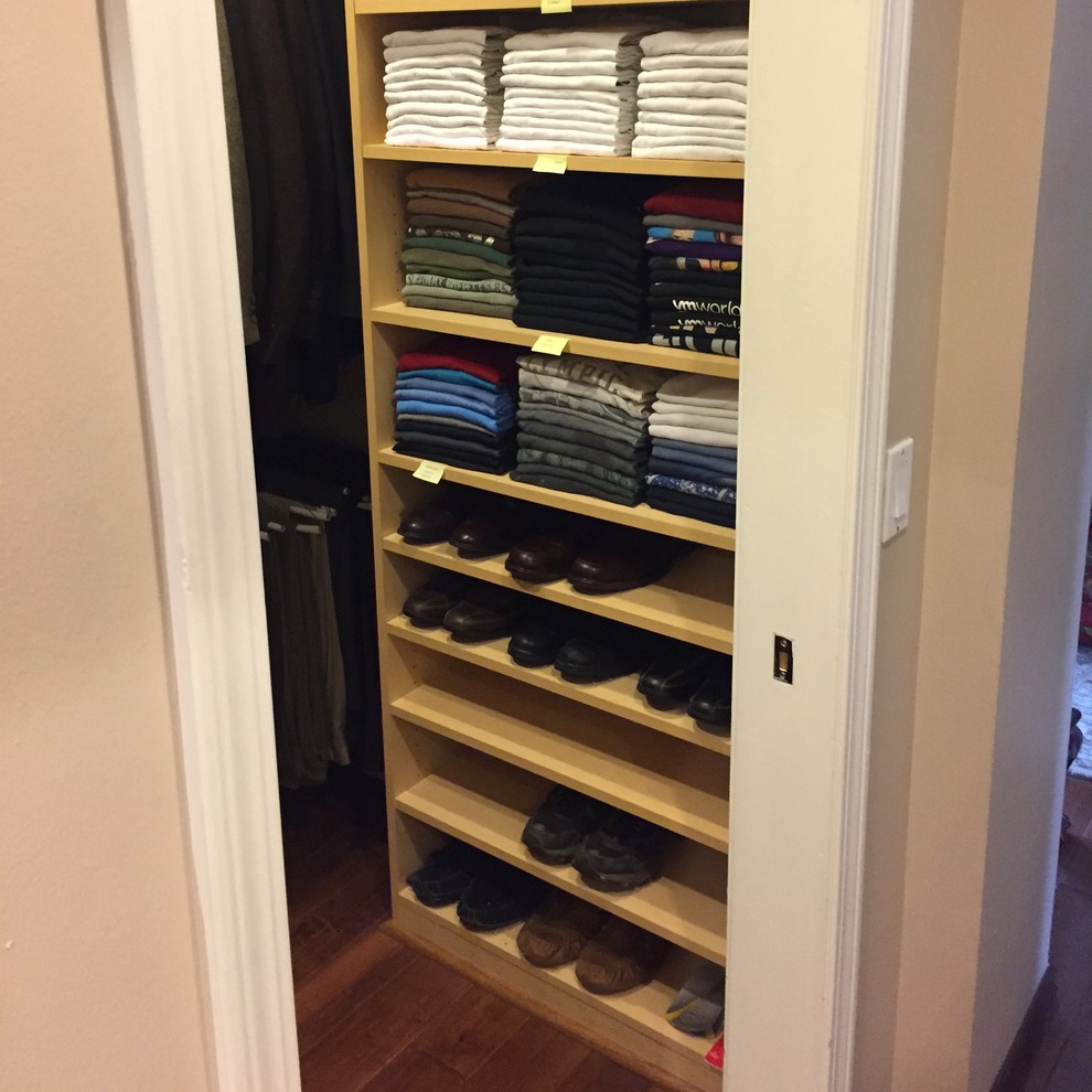 Small classic walk-in wardrobe for men in Los Angeles with open cabinets, light wood cabinets, dark hardwood flooring and brown floors.