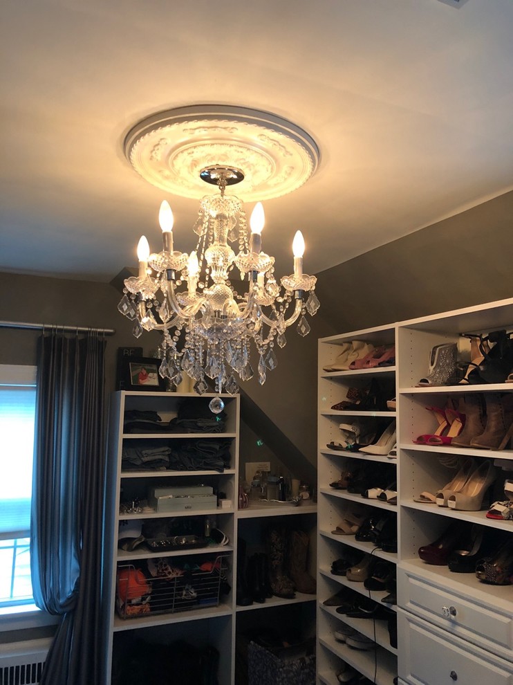 Mid-sized transitional women's light wood floor walk-in closet photo in Boston with raised-panel cabinets and white cabinets