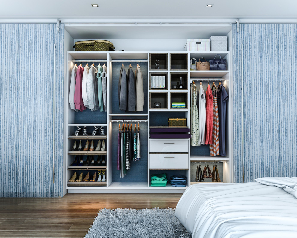 Inspiration for a mid-sized modern reach-in closet remodel in Los Angeles with white cabinets
