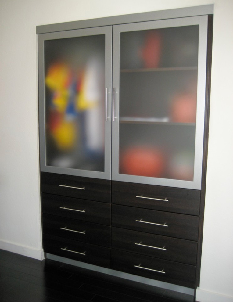 Mid-sized reach-in closet photo in Los Angeles with flat-panel cabinets and gray cabinets