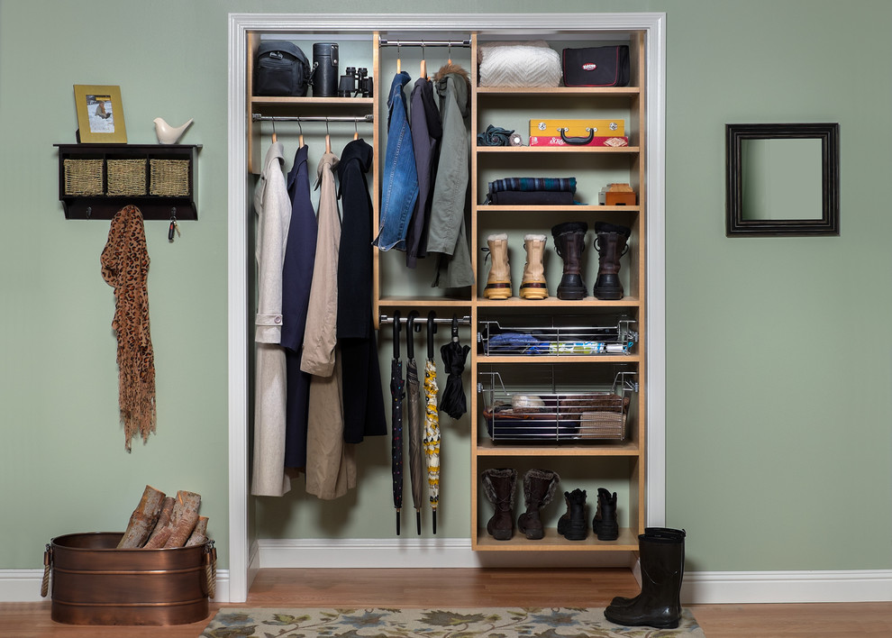 This is an example of a small contemporary gender neutral standard wardrobe in Boston with open cabinets, light wood cabinets and dark hardwood flooring.