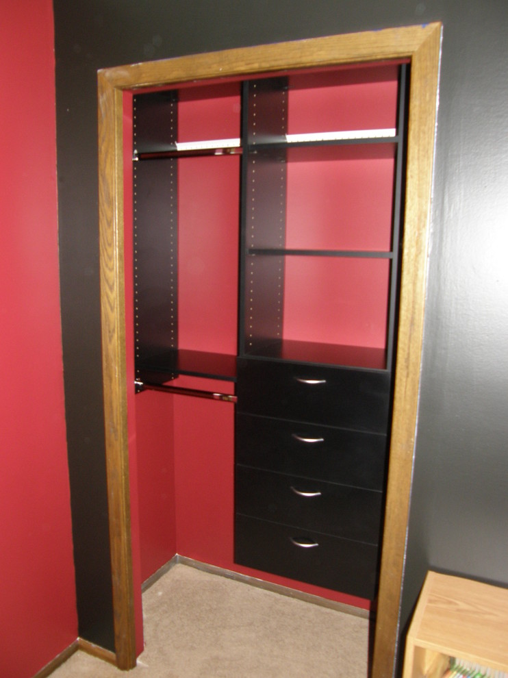 Reach-in closet - mid-sized traditional reach-in closet idea in Minneapolis with open cabinets and black cabinets