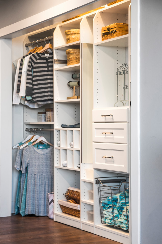 Photo of a gender neutral standard wardrobe in Phoenix with recessed-panel cabinets, white cabinets and medium hardwood flooring.