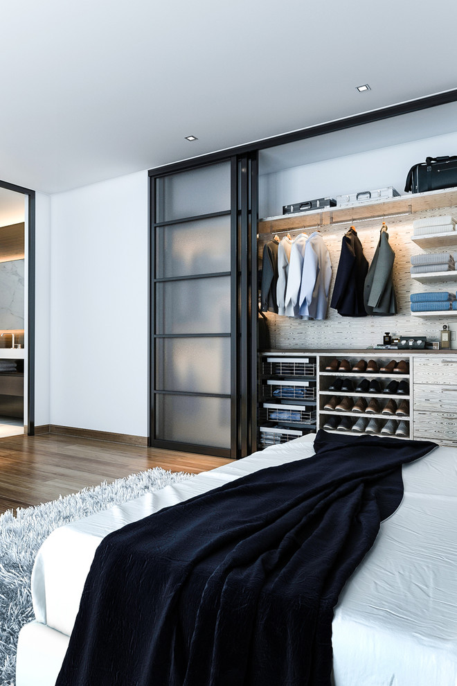 This is an example of a small standard wardrobe in Miami with flat-panel cabinets, light wood cabinets, medium hardwood flooring and brown floors.