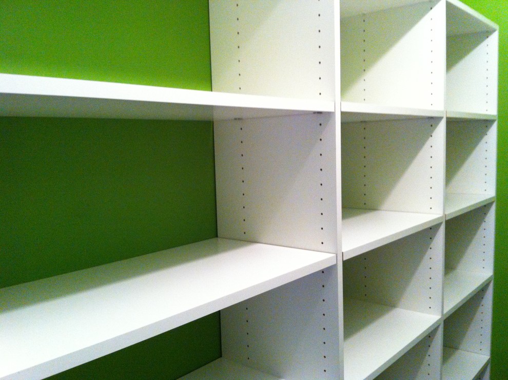 Design ideas for a traditional gender neutral walk-in wardrobe in Birmingham with white cabinets.