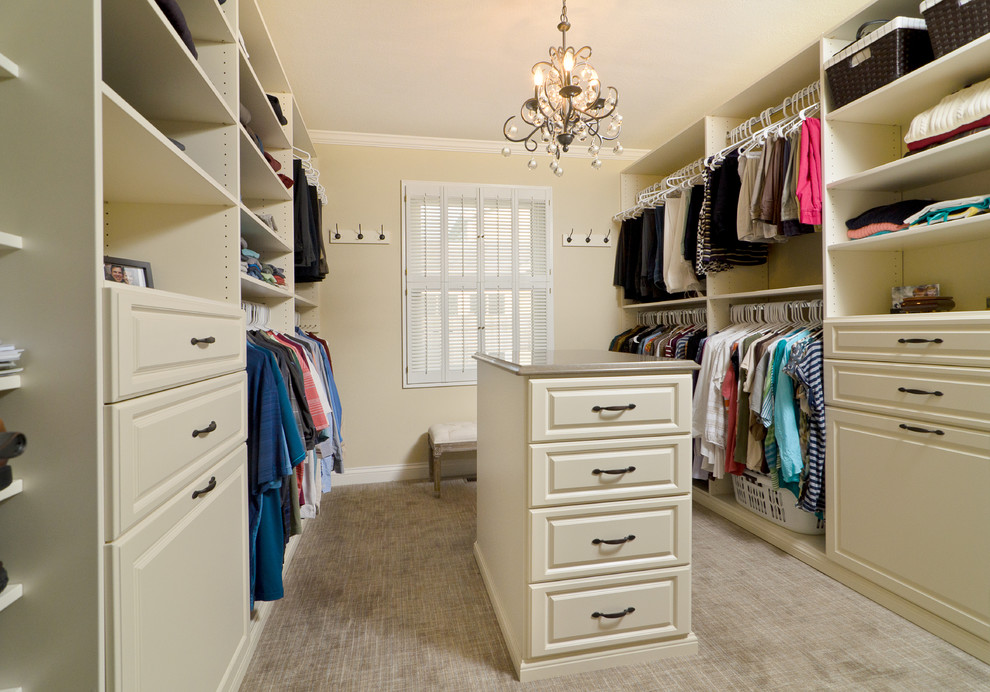 Example of a large transitional gender-neutral carpeted dressing room design in Chicago with raised-panel cabinets and beige cabinets