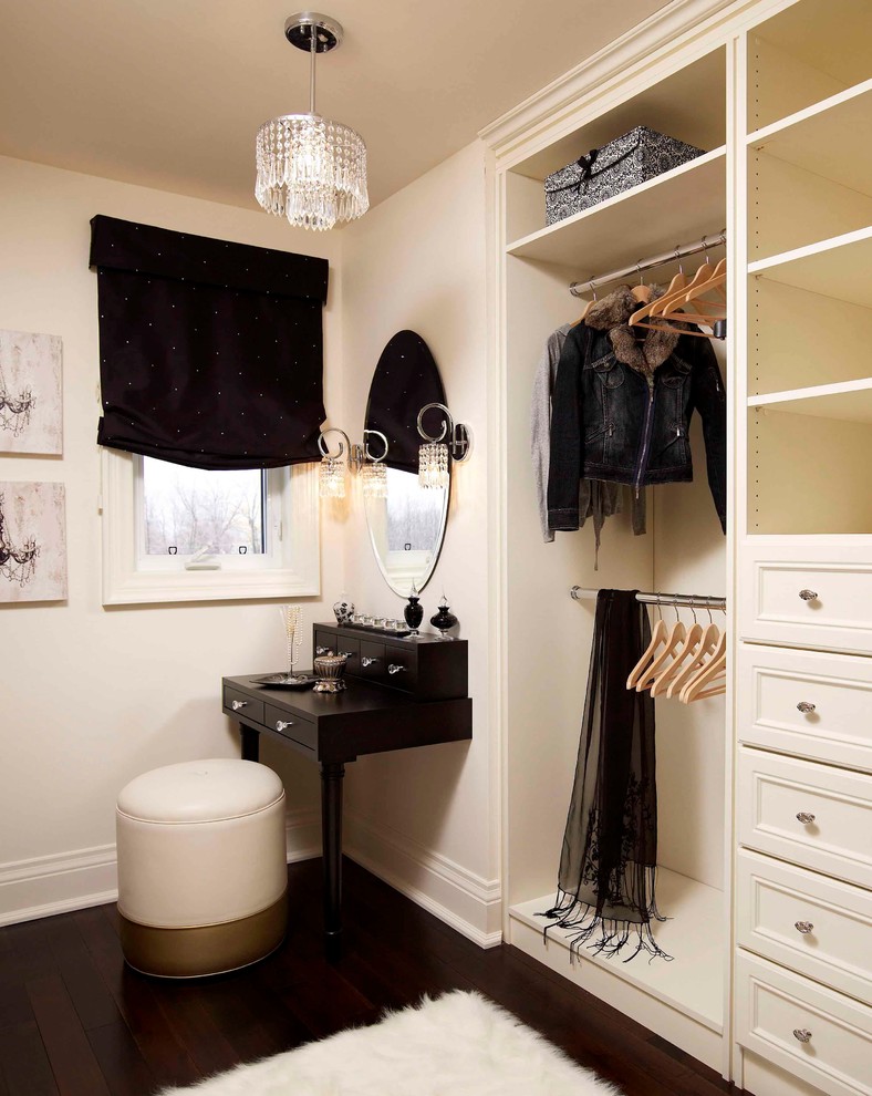 Example of a mid-sized classic women's dark wood floor dressing room design in Toronto with recessed-panel cabinets and white cabinets