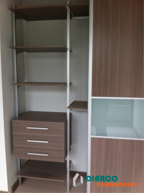Inspiration for a medium sized gender neutral walk-in wardrobe in Other with open cabinets, light wood cabinets and laminate floors.