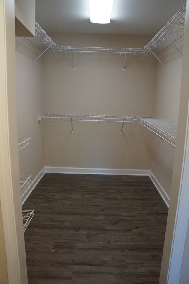 Photo of a medium sized classic gender neutral walk-in wardrobe in Charlotte with laminate floors.