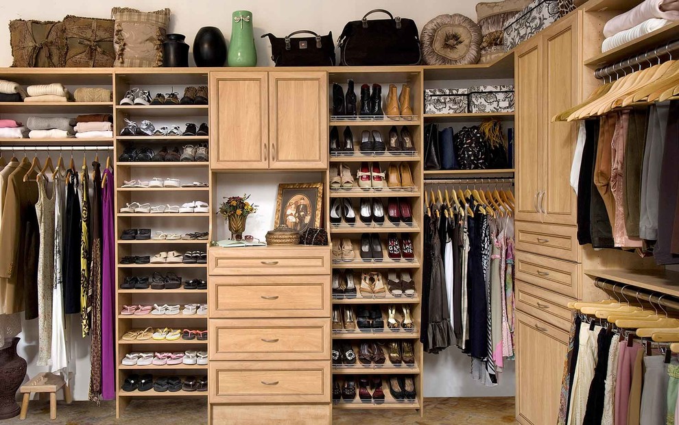 Example of a mid-sized classic gender-neutral slate floor walk-in closet design in San Francisco with raised-panel cabinets and light wood cabinets