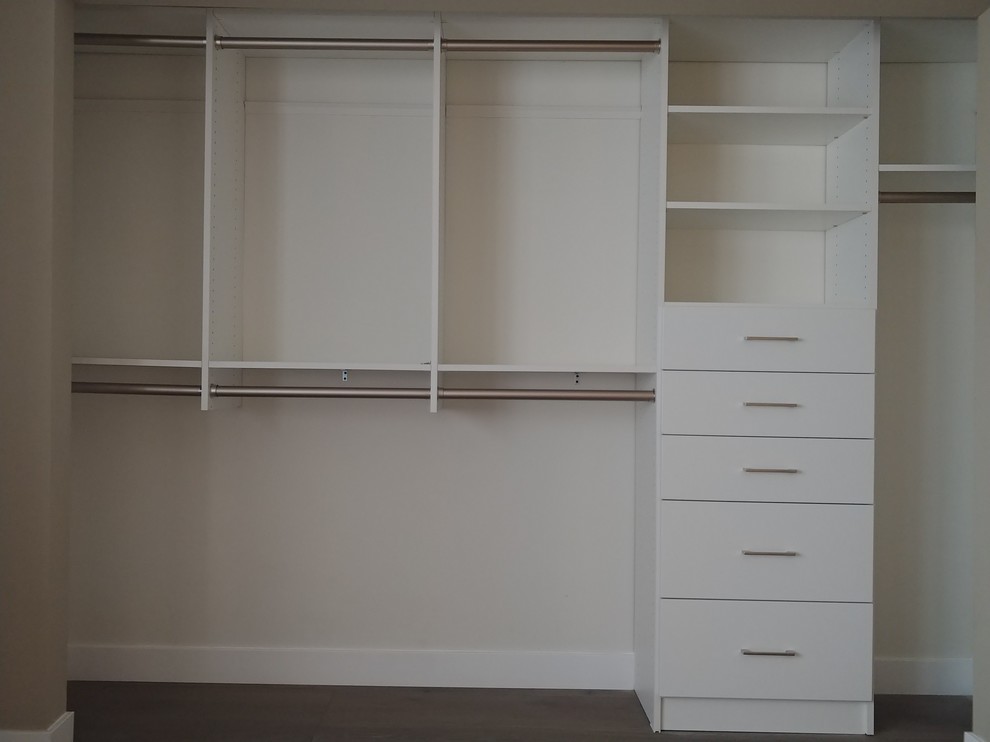 Small minimalist men's reach-in closet photo in Orange County with flat-panel cabinets