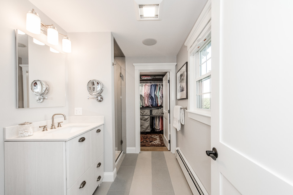 Walk-in closet - mid-sized traditional gender-neutral medium tone wood floor walk-in closet idea in Providence with distressed cabinets