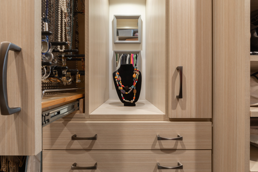 Large mountain style women's carpeted and brown floor walk-in closet photo in Omaha with open cabinets and brown cabinets