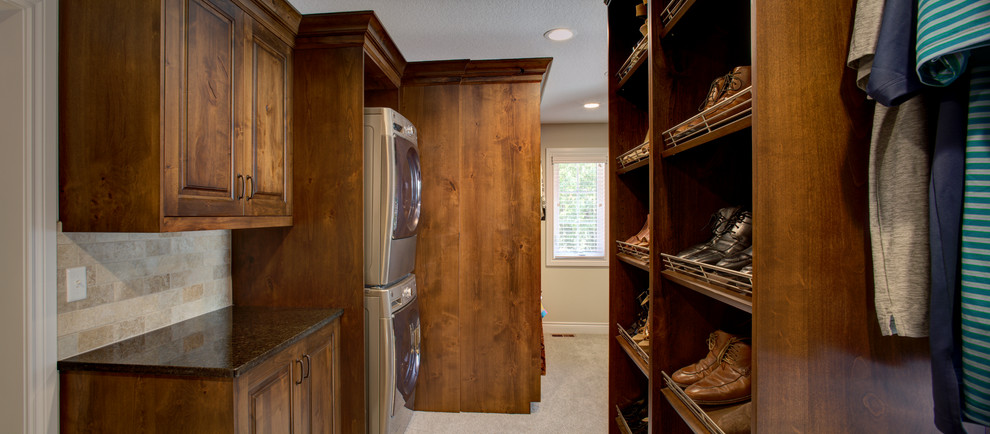 Walk-in closet - large rustic gender-neutral carpeted walk-in closet idea in Kansas City with raised-panel cabinets and medium tone wood cabinets