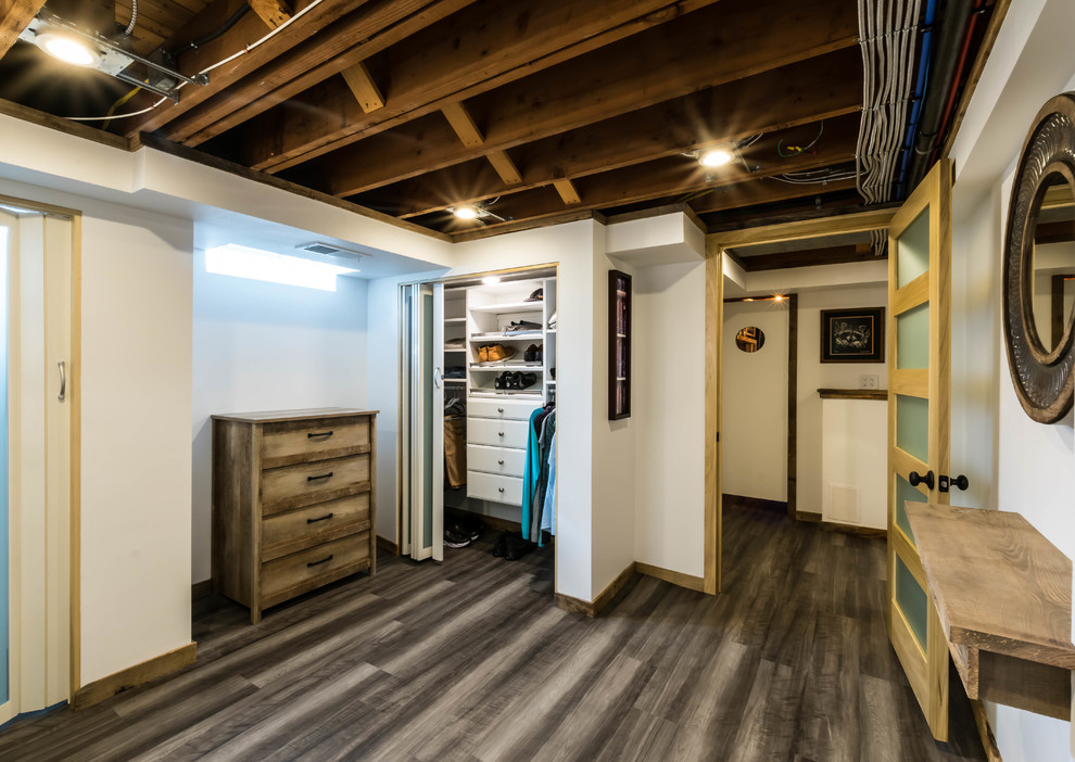 Inspiration for a medium sized rustic gender neutral standard wardrobe in Other with flat-panel cabinets, white cabinets, vinyl flooring and brown floors.