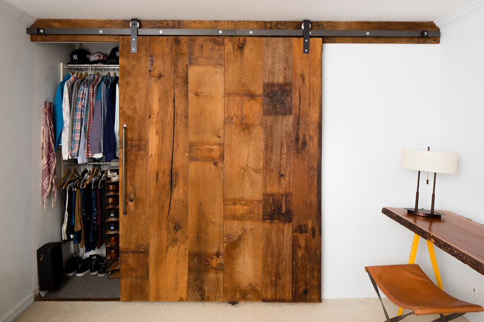 Reach-in closet - small farmhouse men's carpeted reach-in closet idea in New York with flat-panel cabinets and distressed cabinets