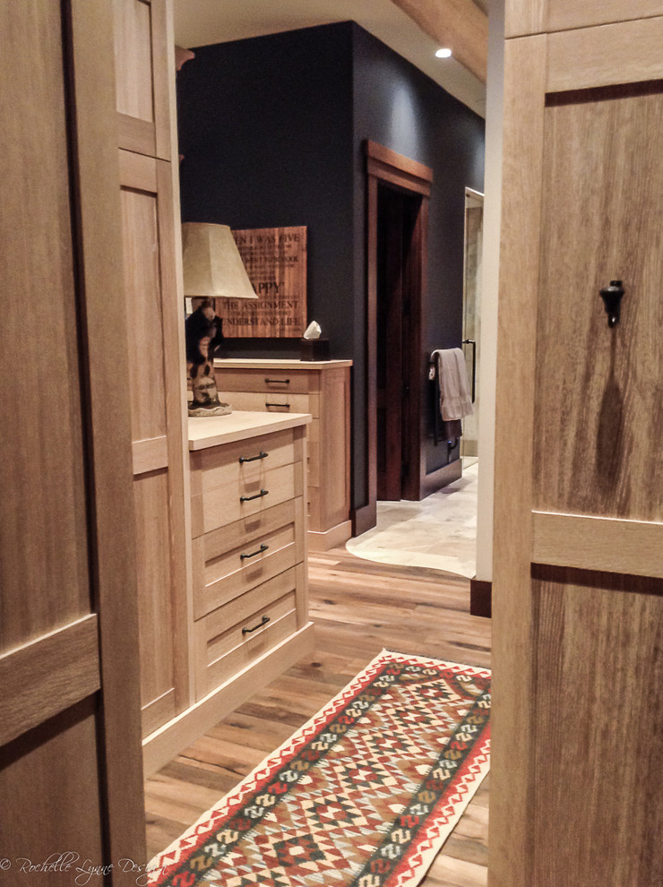 Diseño de vestidor unisex rústico grande con armarios estilo shaker, puertas de armario de madera clara y suelo de madera en tonos medios