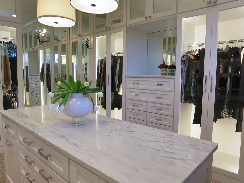 Inspiration for a huge women's carpeted walk-in closet remodel in Atlanta with flat-panel cabinets and white cabinets