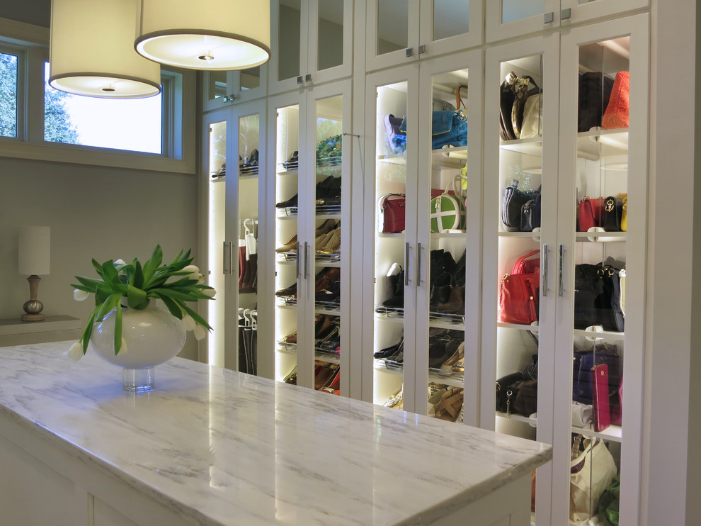 Inspiration for an expansive walk-in wardrobe for women in Atlanta with flat-panel cabinets, white cabinets and carpet.