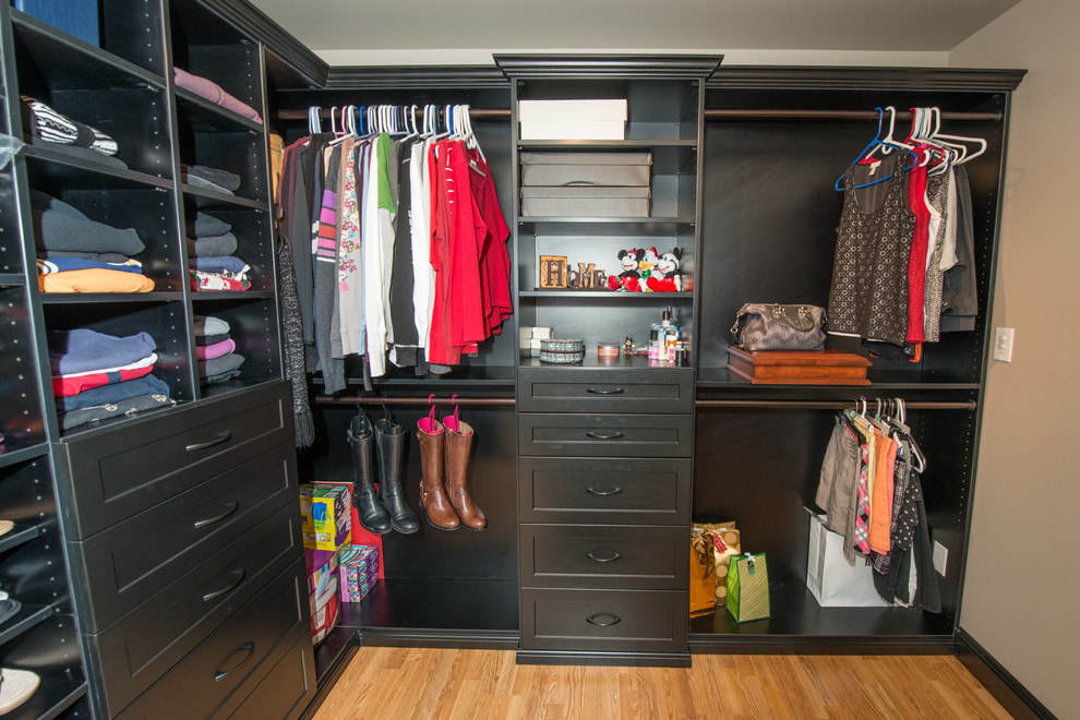 Example of a large transitional gender-neutral light wood floor walk-in closet design in Philadelphia with shaker cabinets and black cabinets