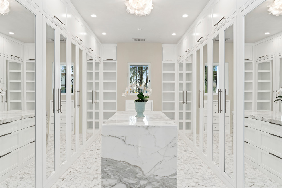 Example of a trendy white floor walk-in closet design in Orange County with recessed-panel cabinets and white cabinets