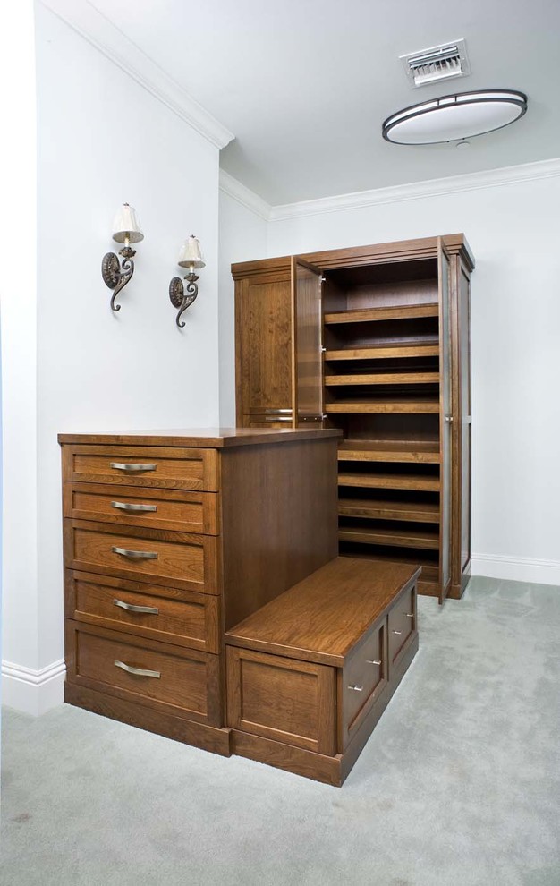 Shaker style enclosed closet with island and bench Eclectic Closet