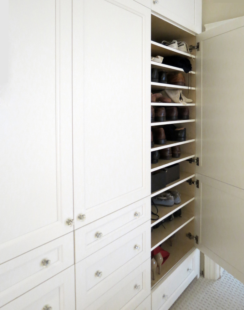 Photo of a small traditional gender neutral standard wardrobe in Toronto with recessed-panel cabinets, white cabinets and carpet.