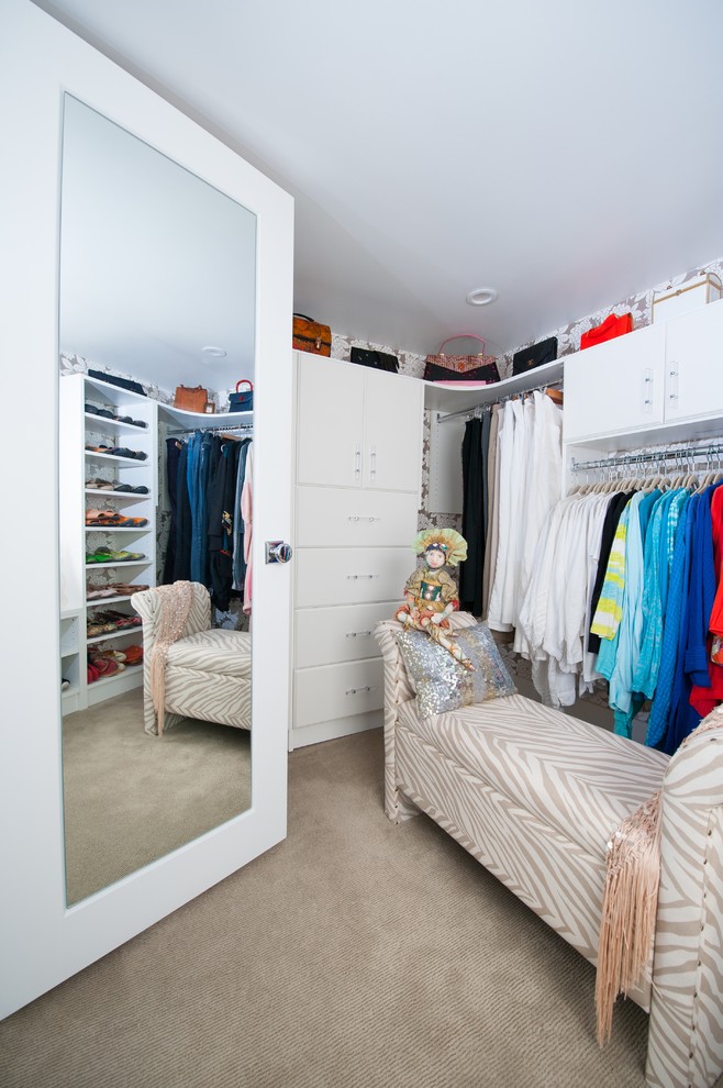 Пример оригинального дизайна: гардеробная комната среднего размера в стиле фьюжн с плоскими фасадами, белыми фасадами и ковровым покрытием для женщин