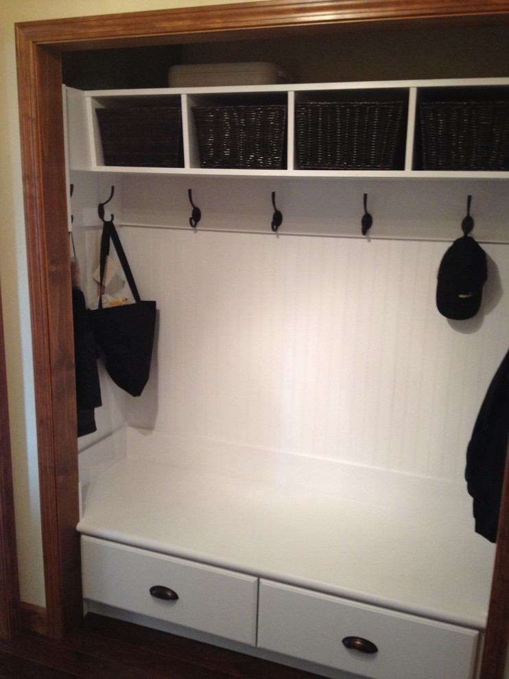 This is an example of a traditional standard wardrobe in Other with flat-panel cabinets and white cabinets.