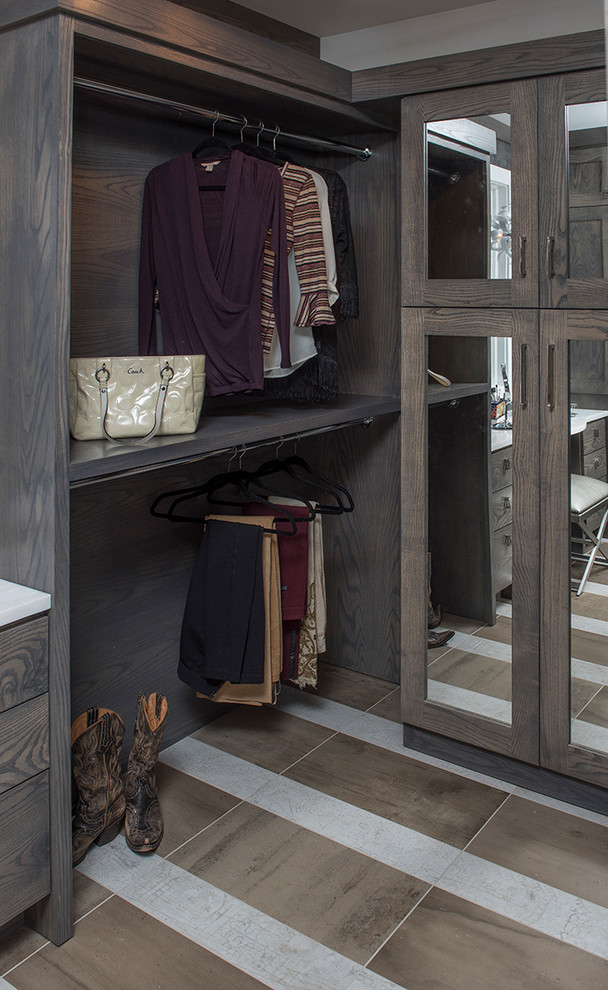 Design ideas for a large rustic gender neutral walk-in wardrobe in Other with open cabinets, dark wood cabinets and multi-coloured floors.