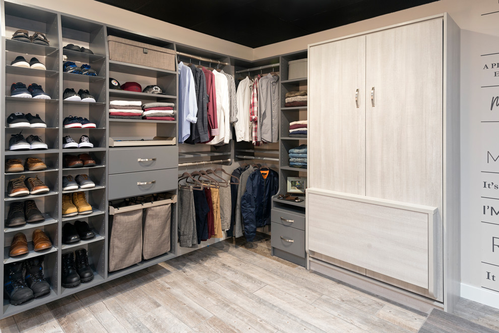 Inspiration for a large contemporary gender neutral walk-in wardrobe in Other with flat-panel cabinets, light wood cabinets, porcelain flooring and beige floors.