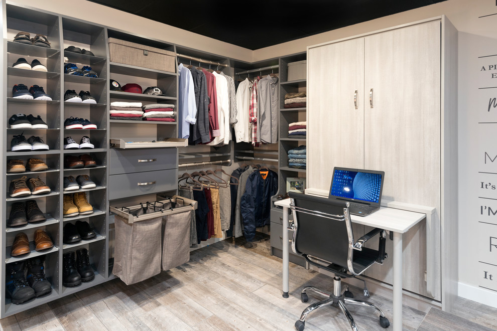 Large contemporary gender neutral walk-in wardrobe in Other with flat-panel cabinets, light wood cabinets, porcelain flooring and beige floors.