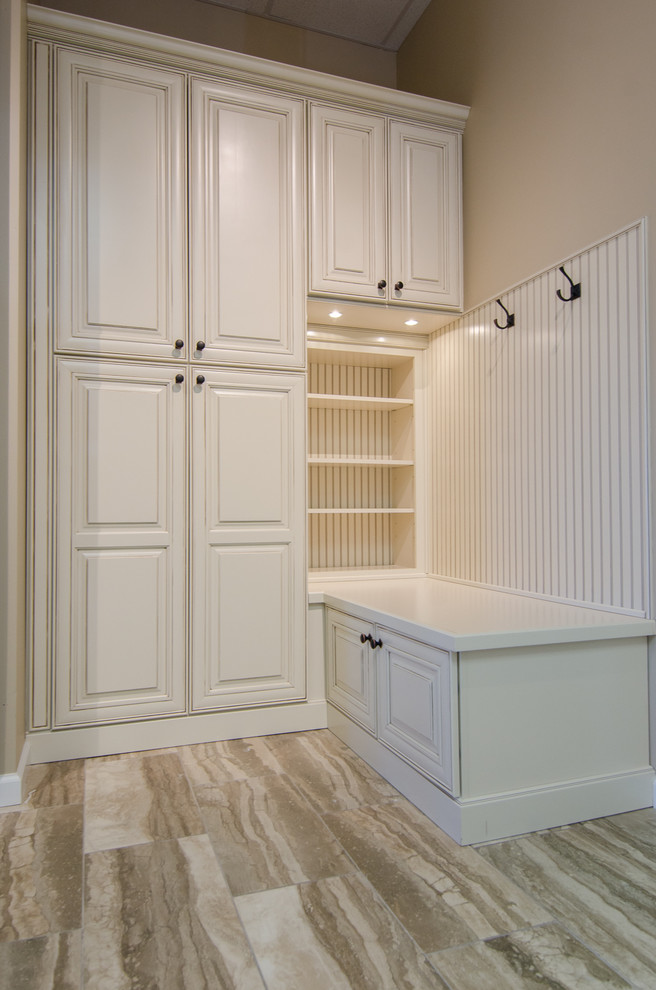 Inspiration for a mid-sized timeless gender-neutral porcelain tile walk-in closet remodel in DC Metro with raised-panel cabinets and white cabinets