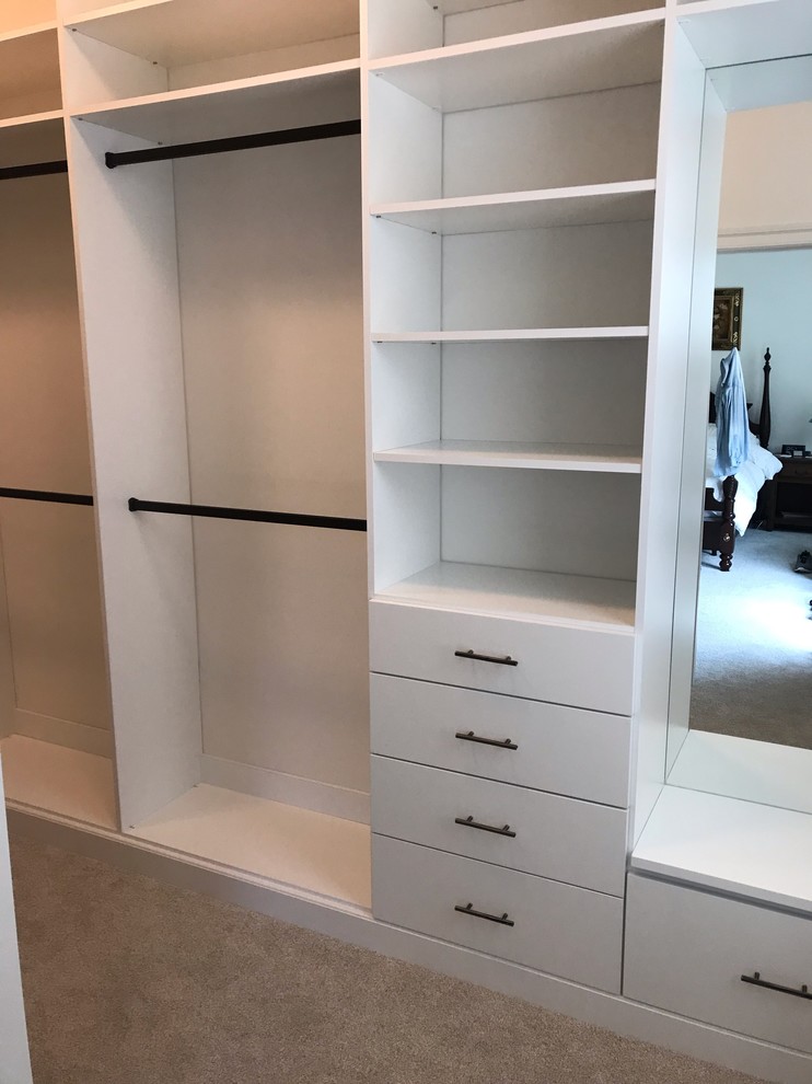 Design ideas for a medium sized classic gender neutral walk-in wardrobe in DC Metro with flat-panel cabinets, white cabinets, carpet and beige floors.