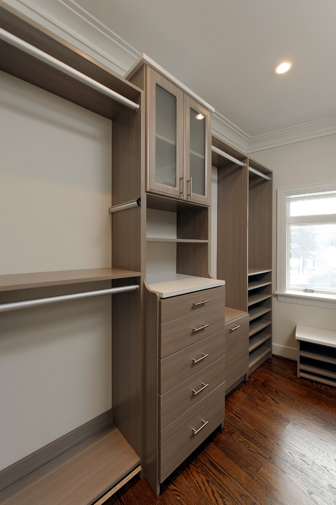 Inspiration for a medium sized contemporary gender neutral dressing room in DC Metro with flat-panel cabinets, light wood cabinets, medium hardwood flooring and brown floors.