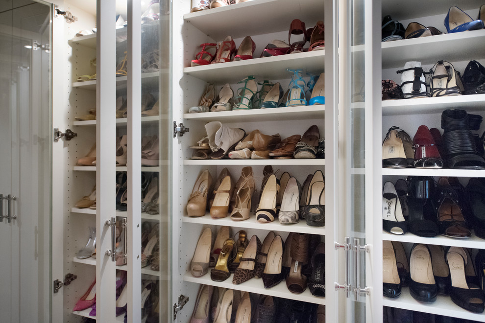 Klassisk inredning av ett mellanstort walk-in-closet för kvinnor, med luckor med glaspanel, vita skåp, mörkt trägolv och brunt golv