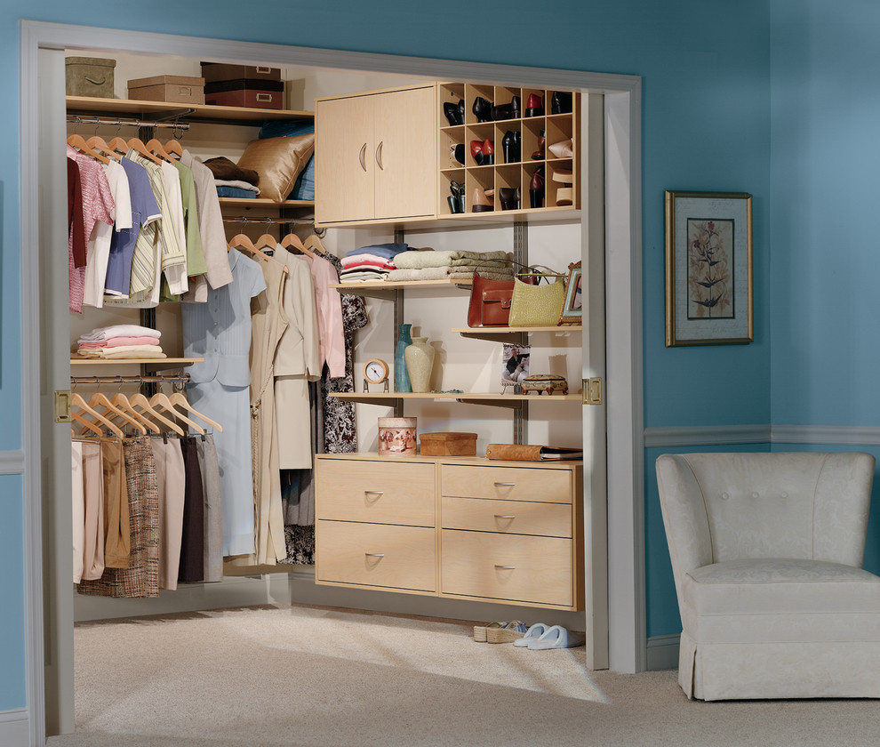 This is an example of a medium sized contemporary gender neutral walk-in wardrobe in Birmingham with flat-panel cabinets.